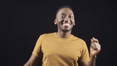 Stylish-and-attractive-African-young-man-looking-at-camera-and-dancing